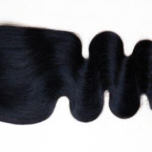 Curly black hair piece laid flat