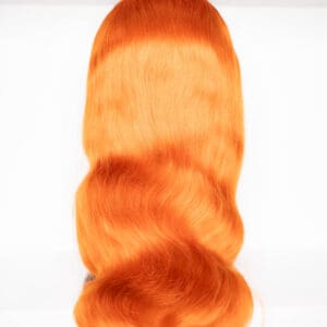 Vibrant orange wavy hair piece displayed flat.